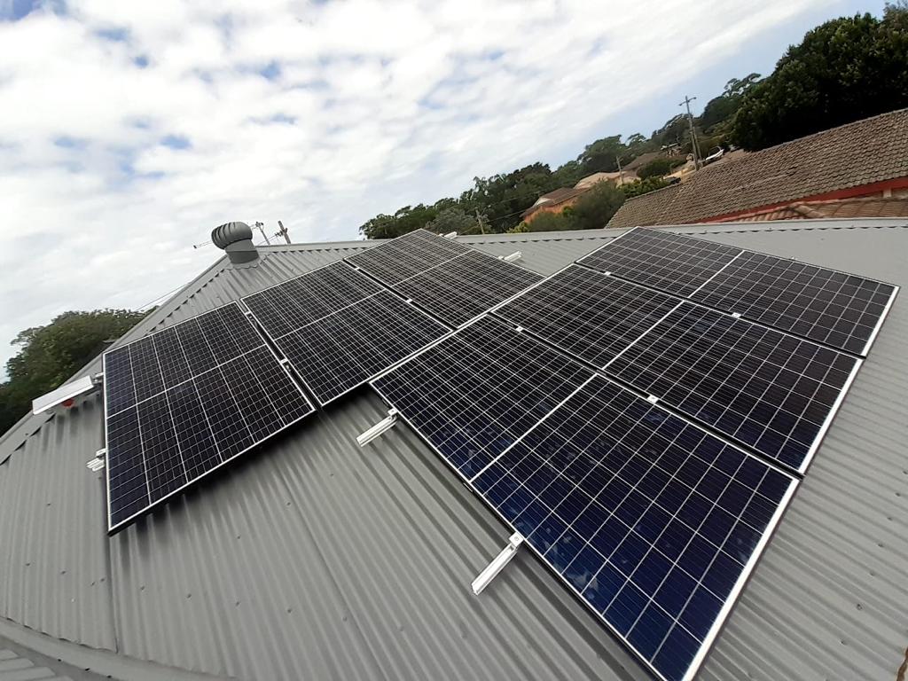 Modern house with solar panel system showing renewable energy upgrade for homeowners