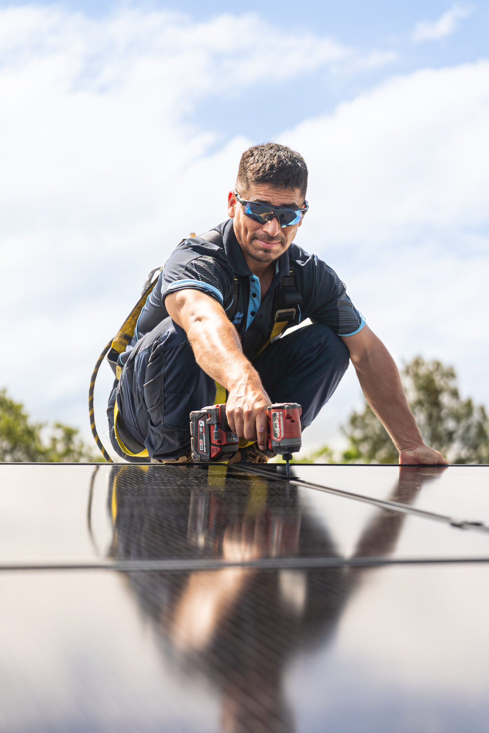 Charlie Sparks solar installer assessing roof with solar panels in Sydney.